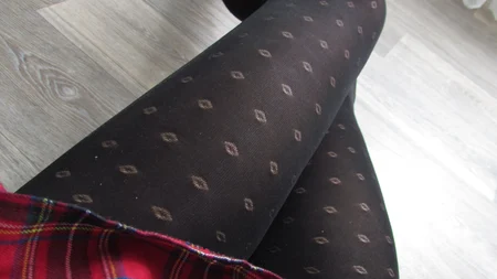 Crossdresser poses in dotted black tights